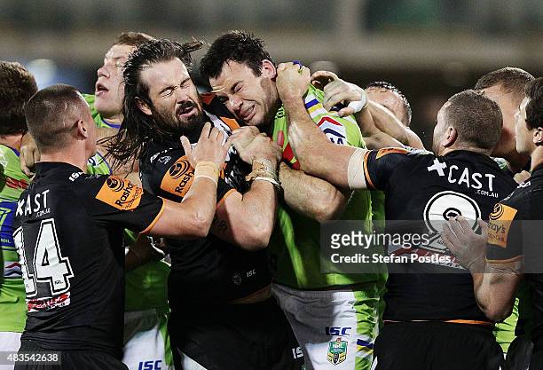 David Shillington of the Raiders head butts Aaron Woods of the Tigers during the round 22 NRL match between the Canberra Raiders and the Wests Tigers...
