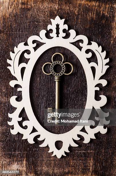 key inside a frame - ornate key stock pictures, royalty-free photos & images