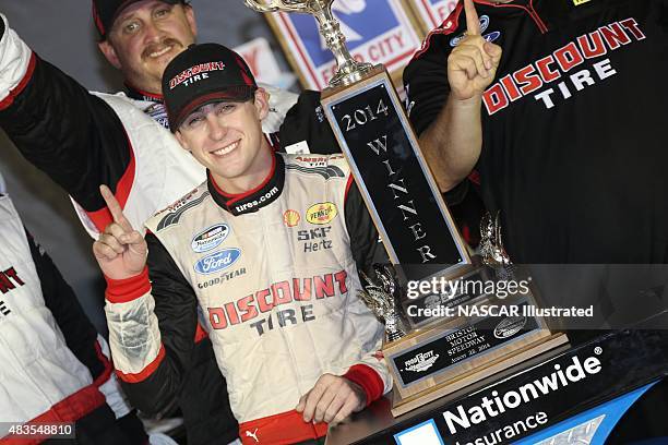 Ryan Blaney, driver of the Discount Tire Ford Mustang, celebrates in victory lane after winning the NASCAR Nationwide Series Food City 300 at the...