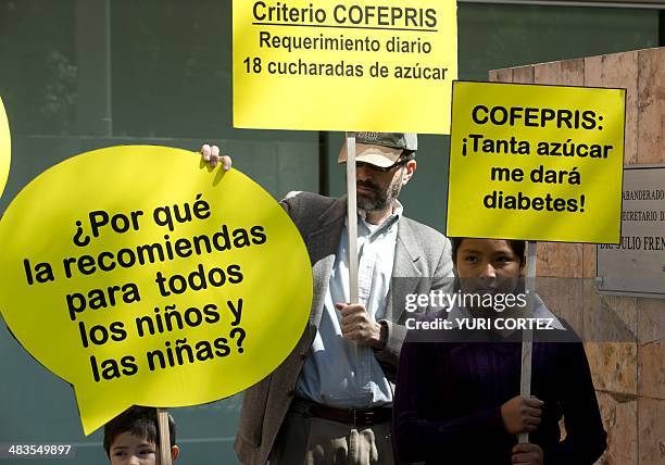 Activists of the Alliance for Health Food hold placards during a rally in front of the Federal Commission for Protection Against Health Risks...