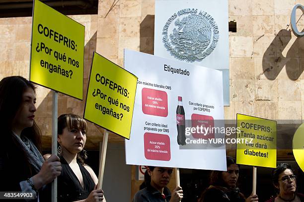 Activists of the Alliance for Health Food hold placards during a rally in front of the Federal Commission for Protection Against Health Risks...