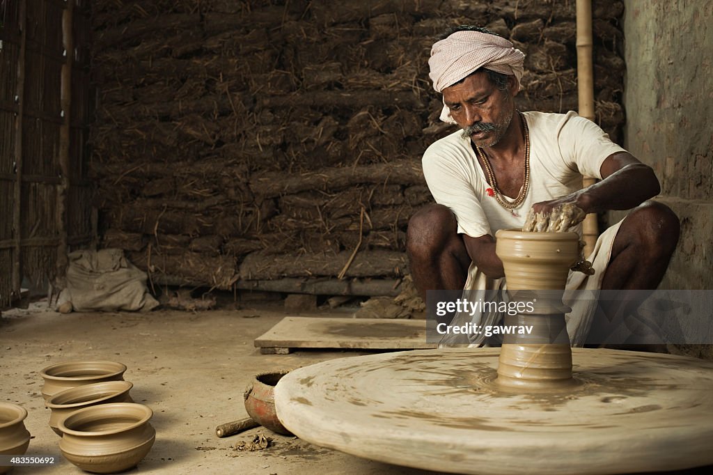 Traditional Indian Potter Making Clay Pot On Manual Pottery Wheel