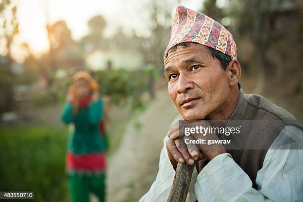 nepalese peasant man thinking and looking at sky in evening. - nepal man stock pictures, royalty-free photos & images