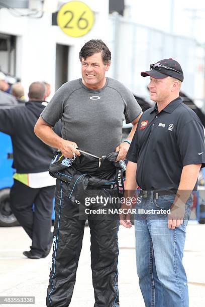 Michael Waltrip, driver of the RoyalTeakCollection.com Toyota Camry, talks with NASCAR team owner Tommy Baldwin Jr. In the garage area during...