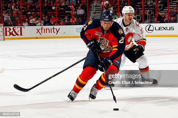 Krys Barch of the Florida Panthers skates with the puck against Lance Bouma of the Calgary Flames at the BB&T Center on April 4, 2014 in Sunrise,...