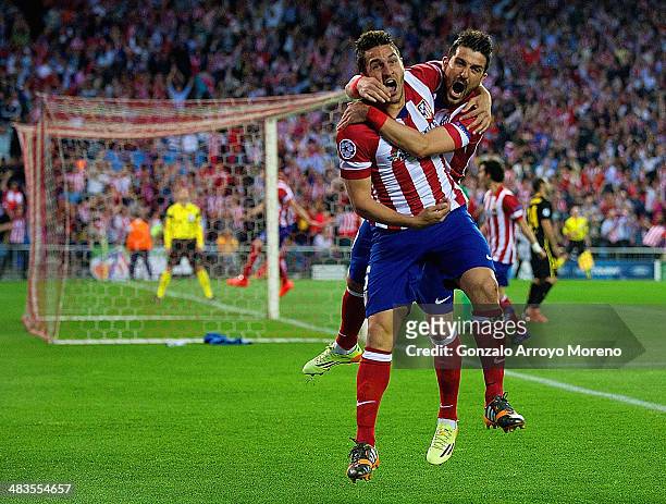 Koke of Club Atletico de Madrid celebrates scoring the opening goal with David Villa of Club Atletico de Madrid during the UEFA Champions League...