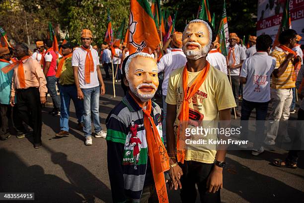 Young supporters of Bharatiya Janata Party leader Narendra Modi wear masks showing his image before Modi filed his nomination papers on April 9, 2014...