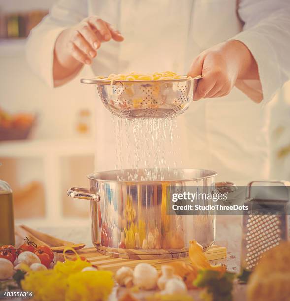 chef cooking spaghetti - spaghetti stock pictures, royalty-free photos & images