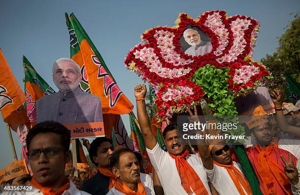 Supporters of Bharatiya Janata Party leader Narendra Modi gather at an event before Modi filed his nomination papers on April 9, 2014 in Vadodra,...