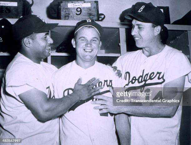 Brooklyn Dodger catcher Roy Campanella, left, and Gil Hodges, right, give Don Zimmer a thumbs up after a game in 1953 in Ebbets Field in Brooklyn,...