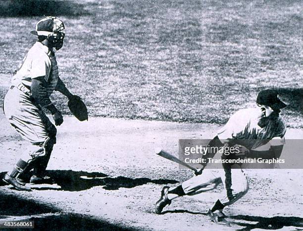 Brooklyn Dodger catcher Roy Campanella watches Mickey Mantle of the New York Yankees head for first base during a game in the World Series in 1955 in...