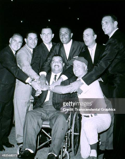 Brooklyn Dodger catcher Roy Campanella, paralyzed in a wheel chair, is joined by his ex-teammates for a get together in 1959 in Brooklyn, New York....