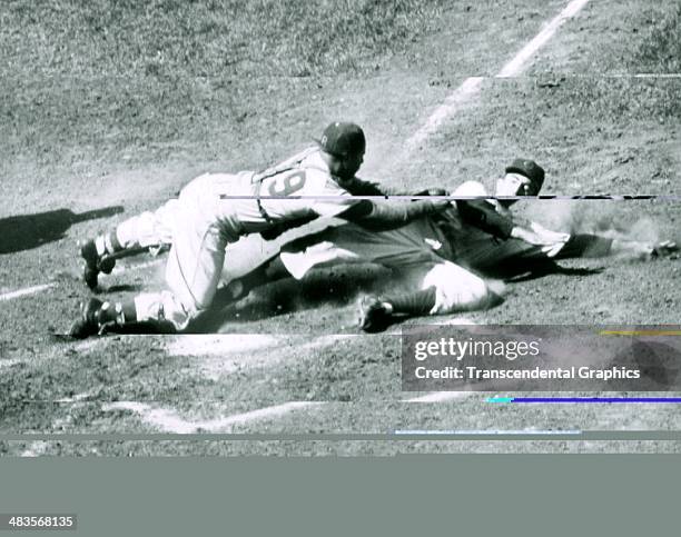 Brooklyn Dodger catcher Roy Campanella tags out the Cubs' Randy Jackson during a game on September 16, 1951 at Wrigley Field in Chicago, Illinois.