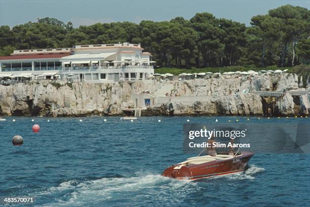 Holidaymakers in a motorboat off the Hotel du Cap-Eden-Roc in Antibes on the French Riviera, 1969.