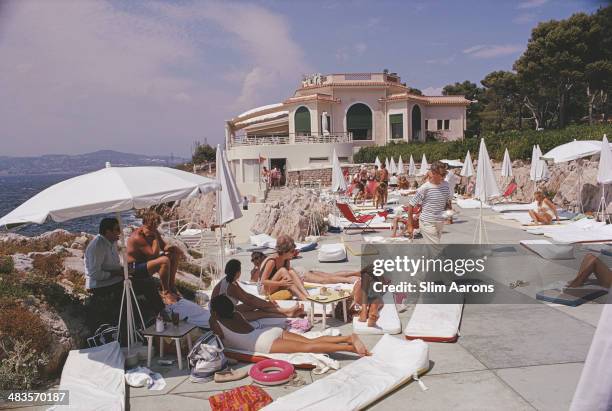 Guests sunbathing on a terrace at the Hotel du Cap-Eden-Roc in Antibes on the French Riviera, August 1969.