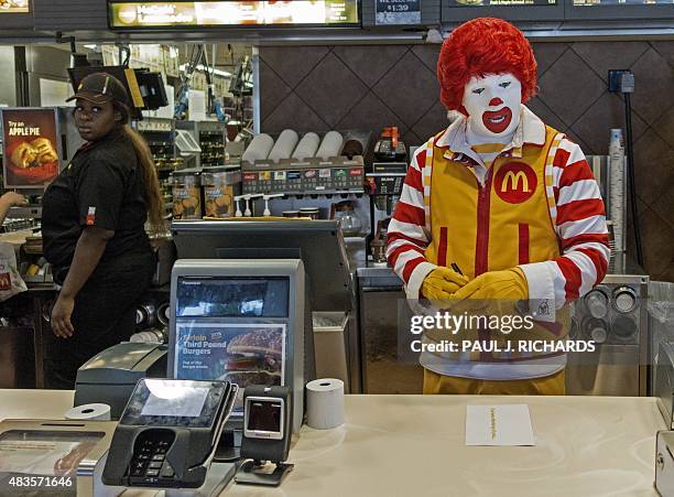 Ronald McDonald stands behind the counter during his appearance at a McDonalds's August 10 in Centreville, Virginia. AFP PHOTO/PAUL J. RICHARDS