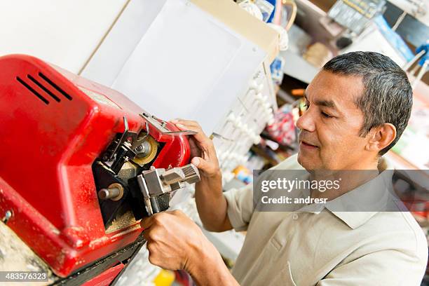 duplicating a house key - key duplication stock pictures, royalty-free photos & images