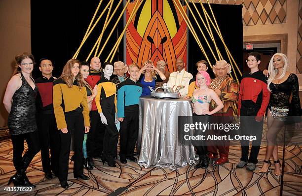 Actress Chase Masterson from 'Star Trek Deep Space Nine' poses with cosplayers inside Quark's Bar at the 14th annual official Star Trek convention at...