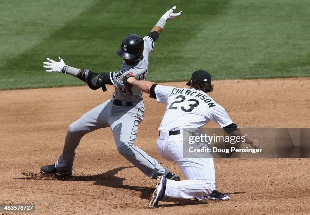 Alexei Ramirez of the Chicago White Sox is safe at second base as second baseman Charlie Culberson of the Colorado Rockies takes the late throw in...