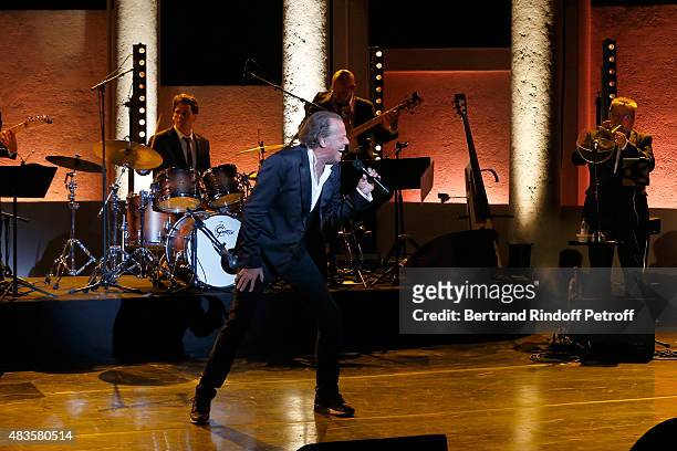 Humorist Michel Leeb performs in his 'Michel Leeb Part en Live !' show, accompanied by the music band 'The Messangers', during the 31th Ramatuelle...