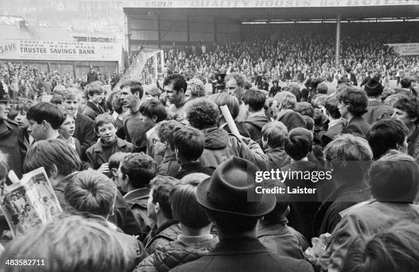 Swansea City players being bombarded by fans, following their win in a testimonial football match with Leeds United, 26th May 1968.