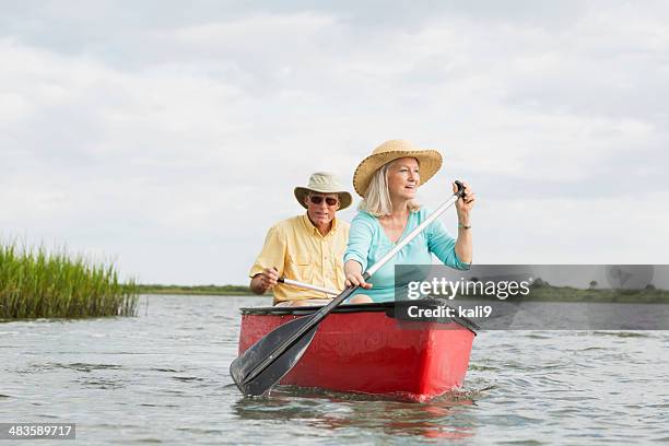 senior couple canoeing on intracoastal waterway, florida - two people canoeing on a lake stock pictures, royalty-free photos & images