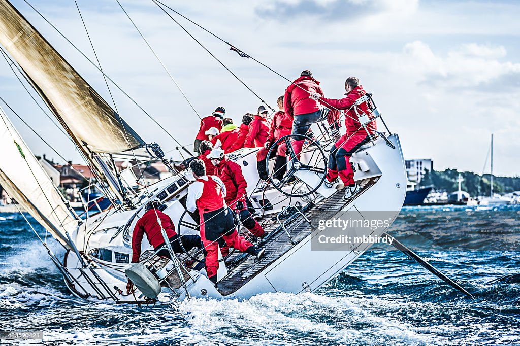 Sailing crew on sailboat during regatta