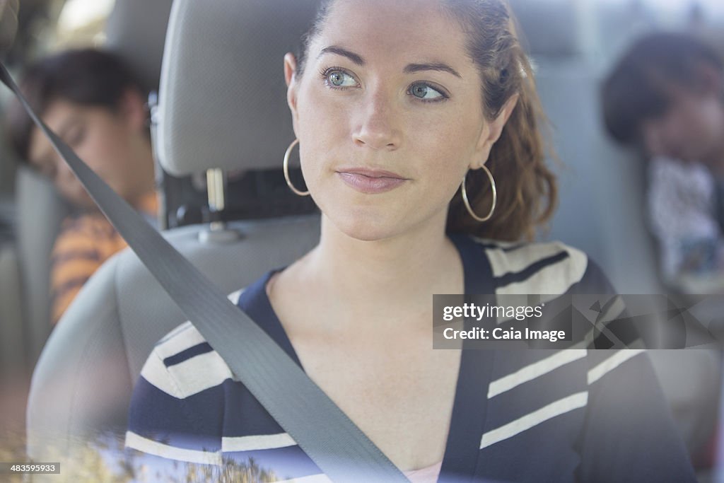 Pensive woman inside car