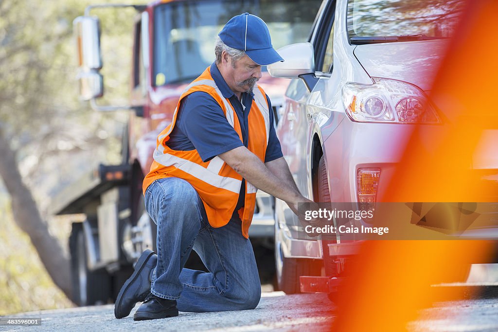 Roadside mechanic repairing flat tire