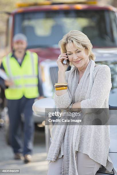 roadside mechanic arriving to help woman on cell phone - man talking to camera stock pictures, royalty-free photos & images