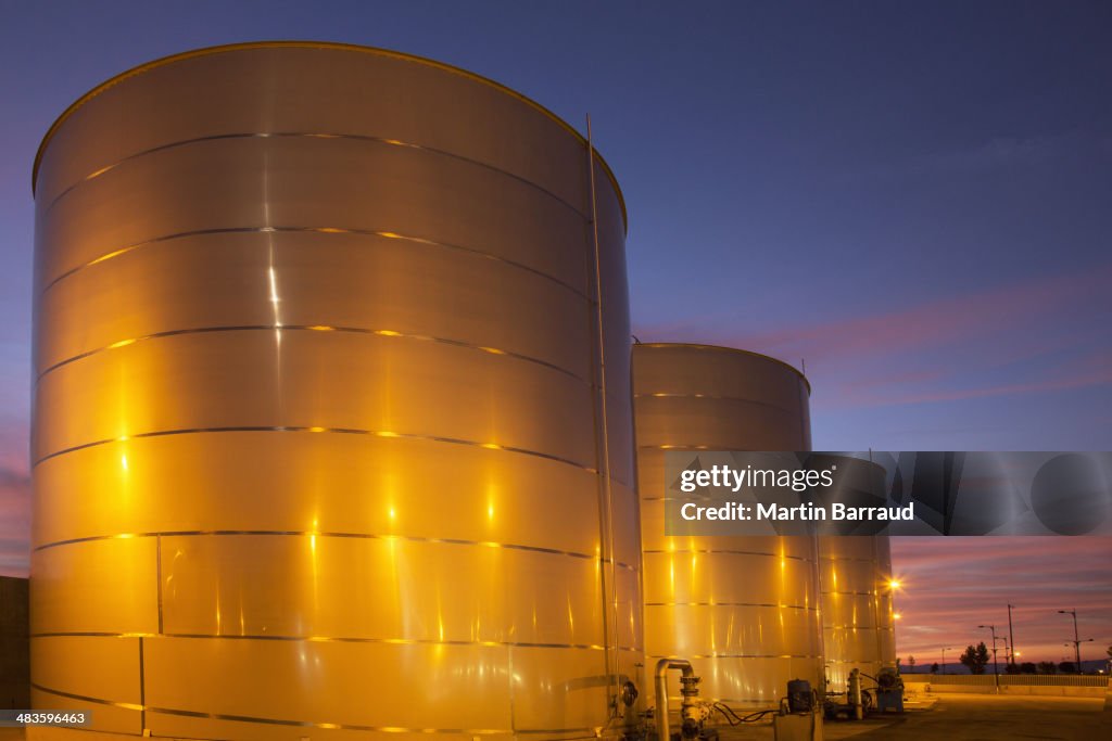 Silage storage tanks illuminated at night