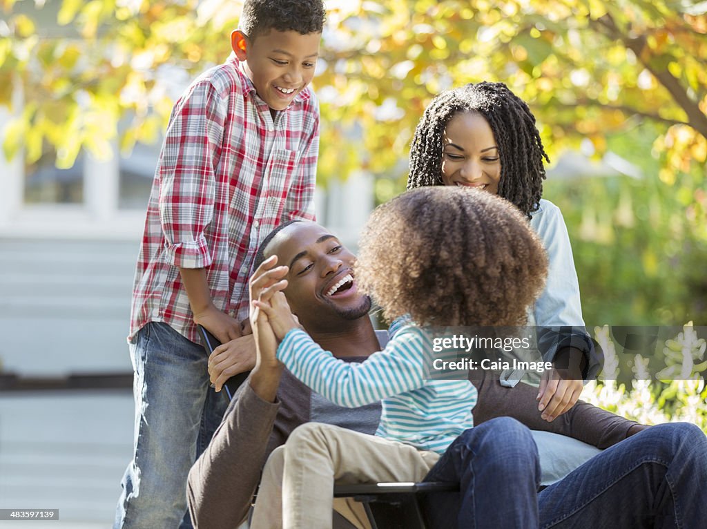 Happy family laughing outdoors