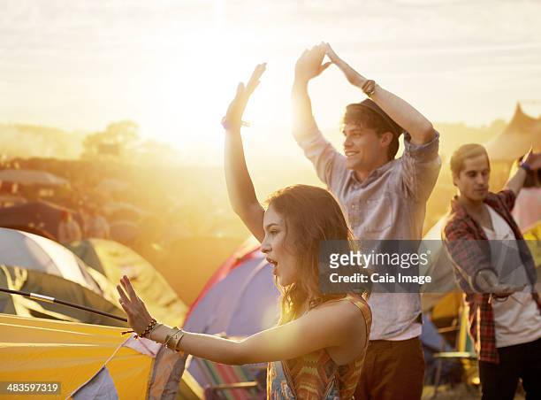 friends dancing outside tents at music festival - hangout festival day 3 stockfoto's en -beelden