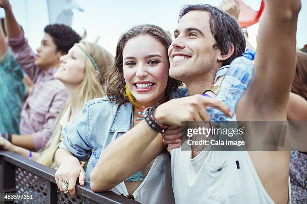 couple cheering at music festival - front row photos stock pictures, royalty-free photos & images