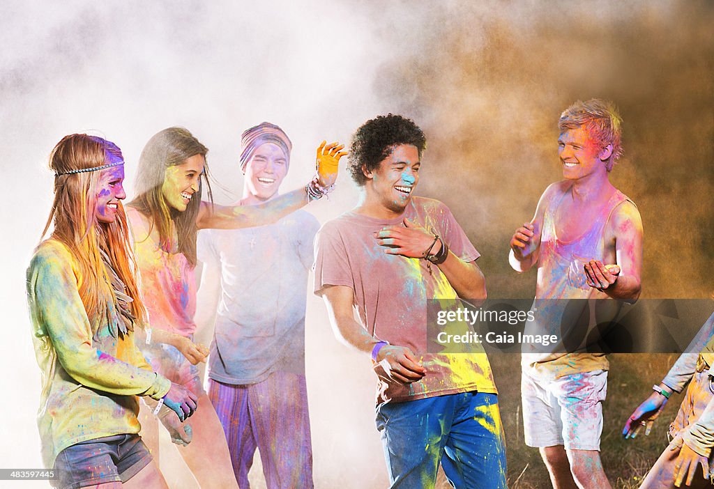 Friends covered in chalk dye at music festival