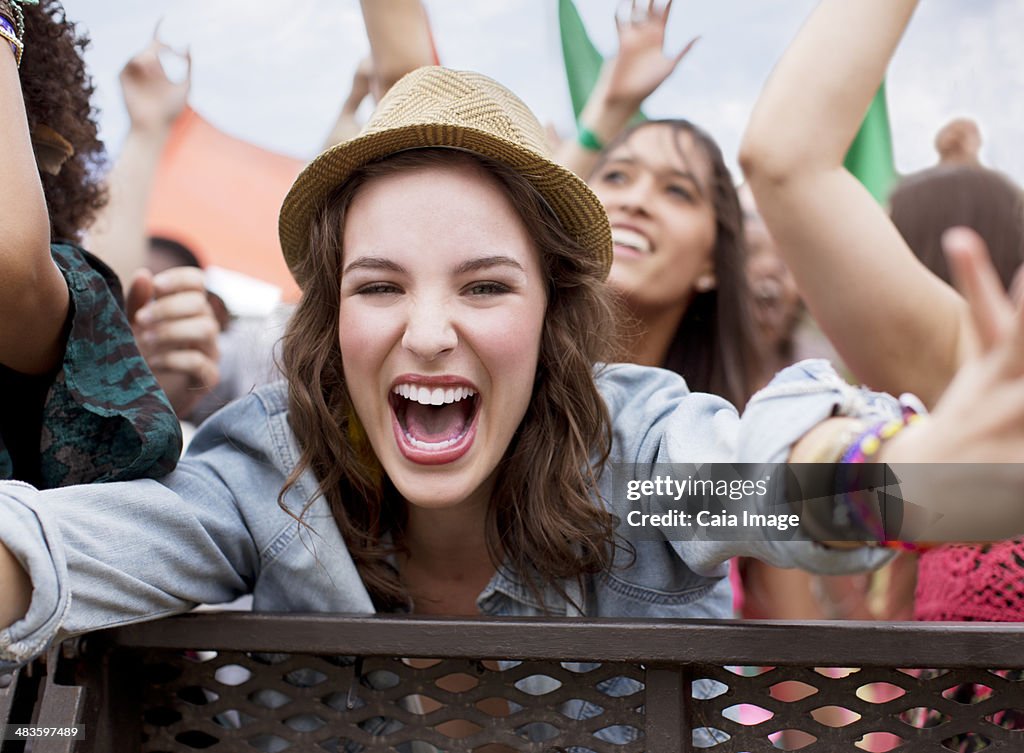 Close up of cheering woman at music festival