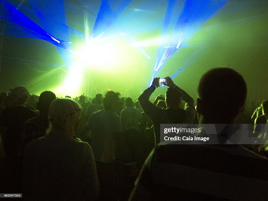 Silhuetas de multidão de iluminado fase no festival de Música