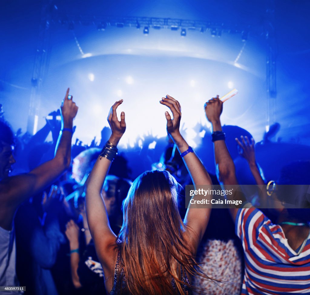 Fans dancing and cheering at music festival