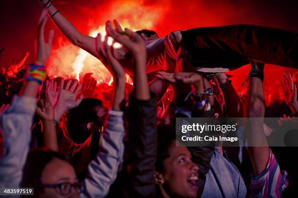 man crowd surfing at music festival - crowd surfing stock pictures, royalty-free photos & images