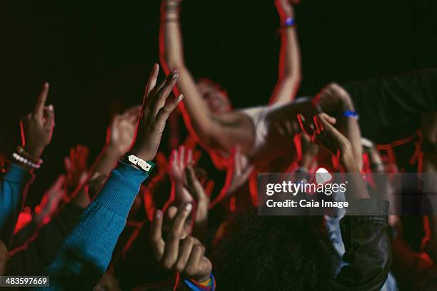 man crowd surfing at music festival - crowd surfing stock pictures, royalty-free photos & images