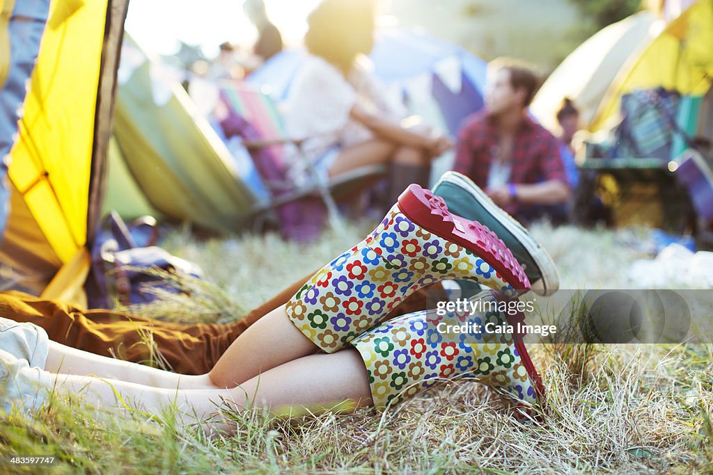 Coupleês legs sticking out of tent at music festival