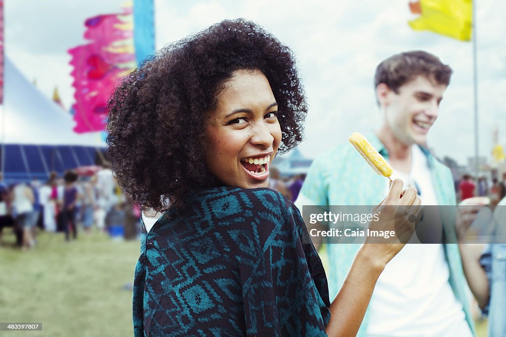 Portrait of woman eating flavored ice at music festival