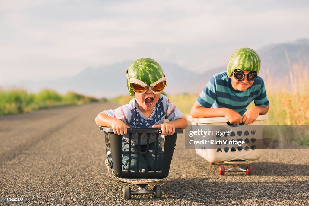 Young Boys Racing Wearing Watermelon Helmets