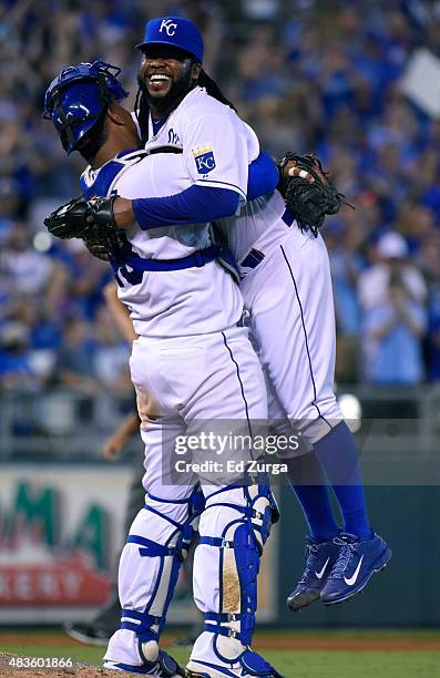 Johnny Cueto of the Kansas City Royals is hugged and picked up by Salvador Perez after throwing a complete game shutout against the Detroit Tigers at...