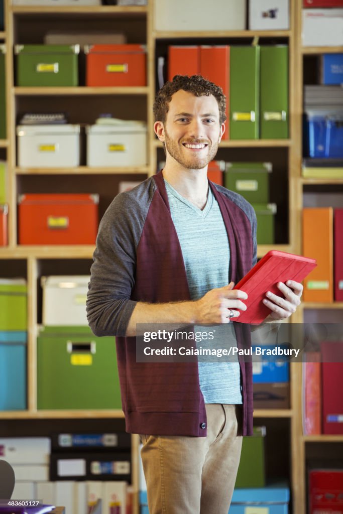Portrait of confident creative businessman holding digital tablet