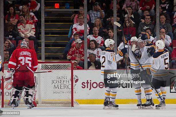 Nicolas Deslauriers of the Buffalo Sabres celebrates his first NHL goal with teammates Chad Ruhwedel, Johan Larsson and Luke Adam as goaltender Jimmy...