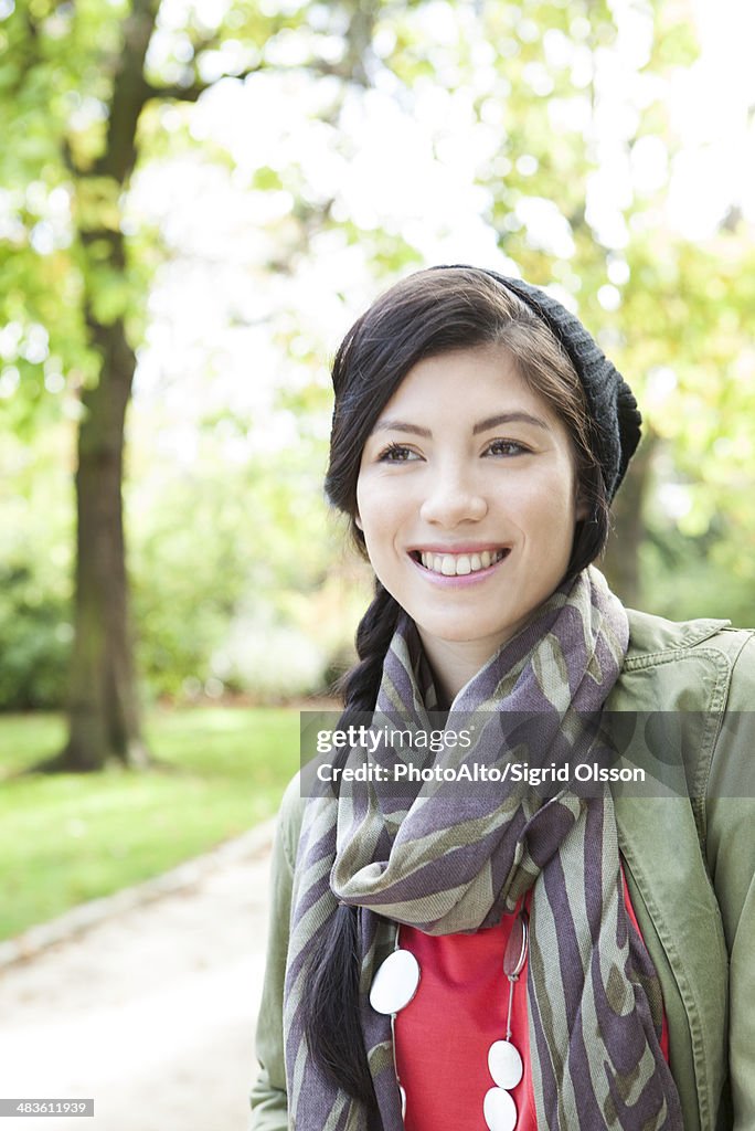 Young woman smiling in park, portrait