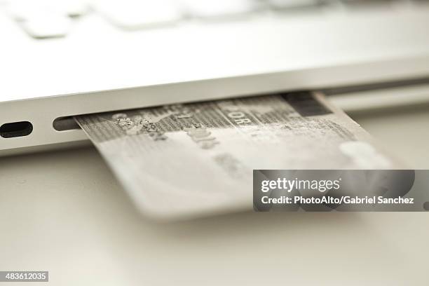 Credit Card Sticking Out Of Side Of Laptop Computer, Foto de stock