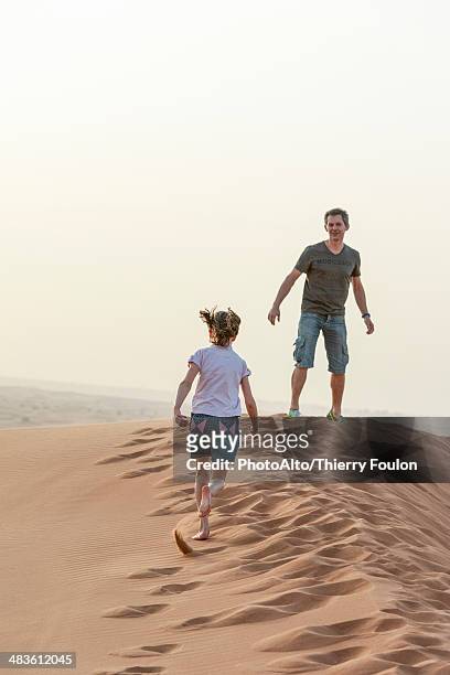 person running up sand dune, cropped - hot arabic girl stock pictures, royalty-free photos & images