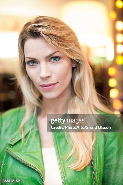 woman wearing green leather jacket, portrait - una mujer de mediana edad solamente fotografías e imágenes de stock